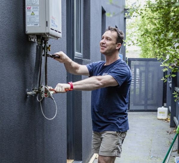 local plumber working on hot water repairs